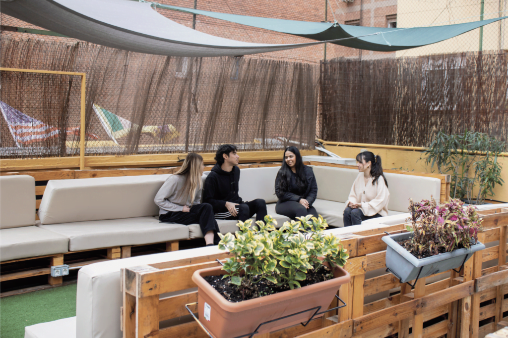Group of travelers in a terrace at Onefam Les Corts Hostel in Barcelona