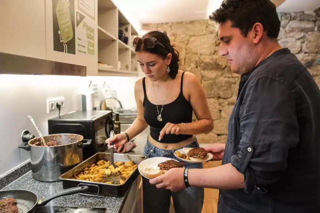 Group of travelers in a kitchen at Onefam Ribeira Hostel in Porto