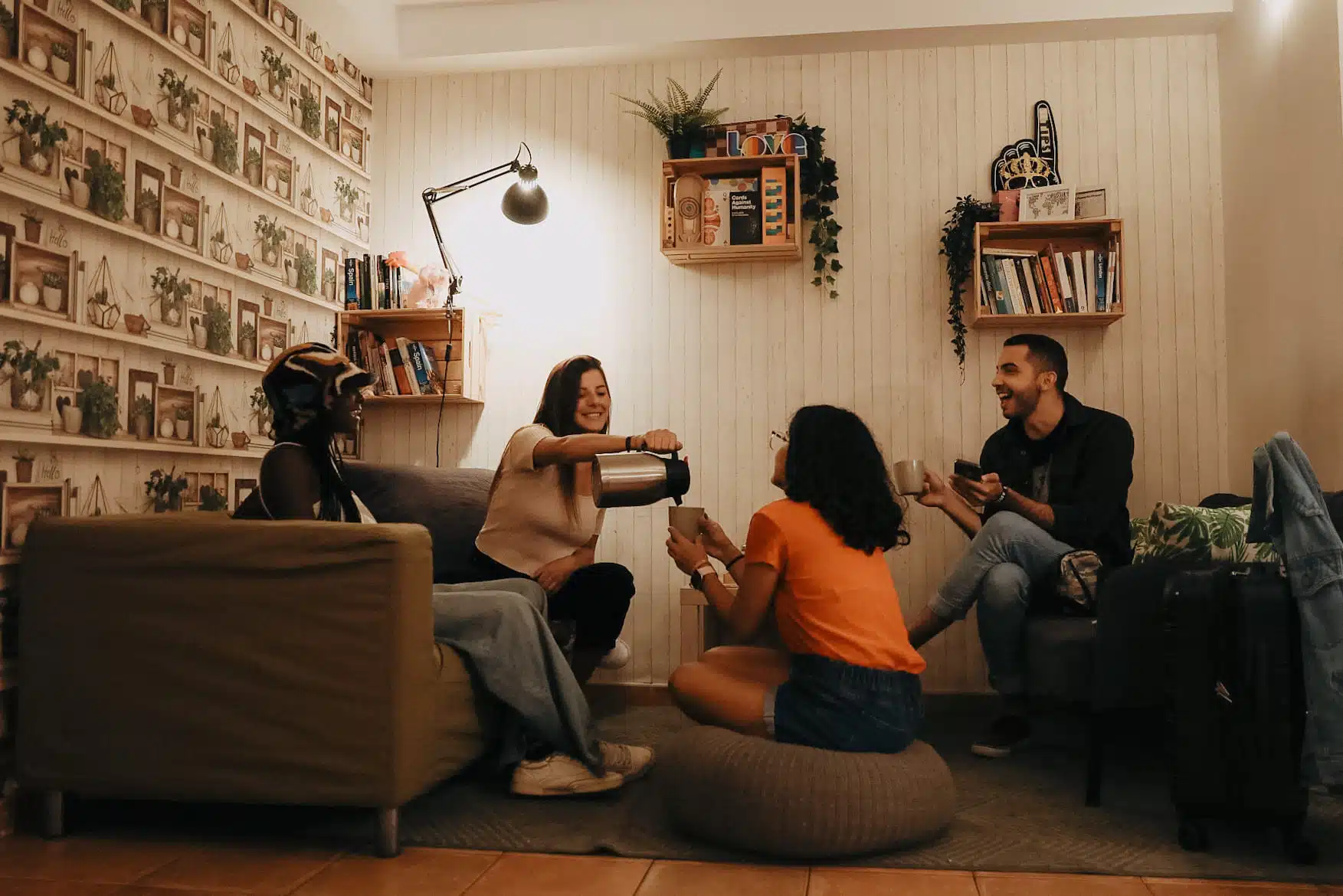 Group of solo travellers having coffe and chatting at Onefam Batllo, hostel in Barcelona