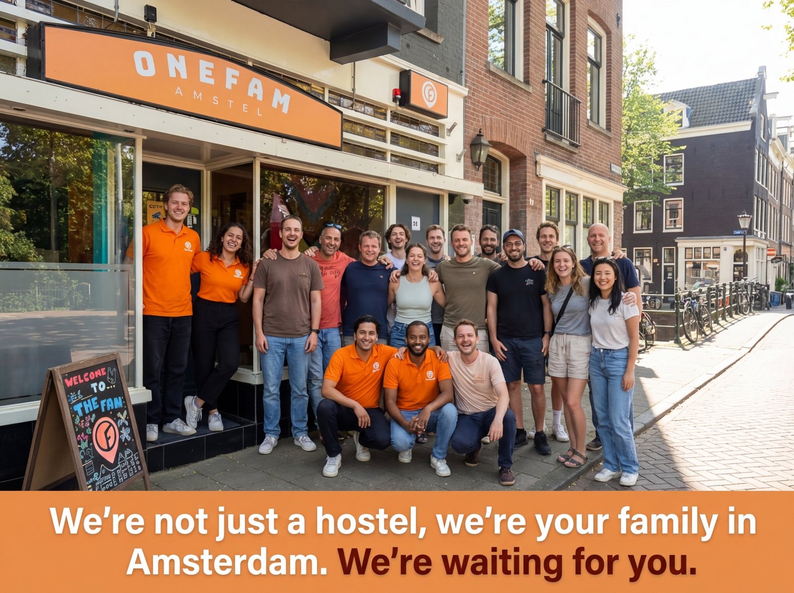 Smiling staff and international guests posing together outside Onefam Amstel hostel in Amsterdam