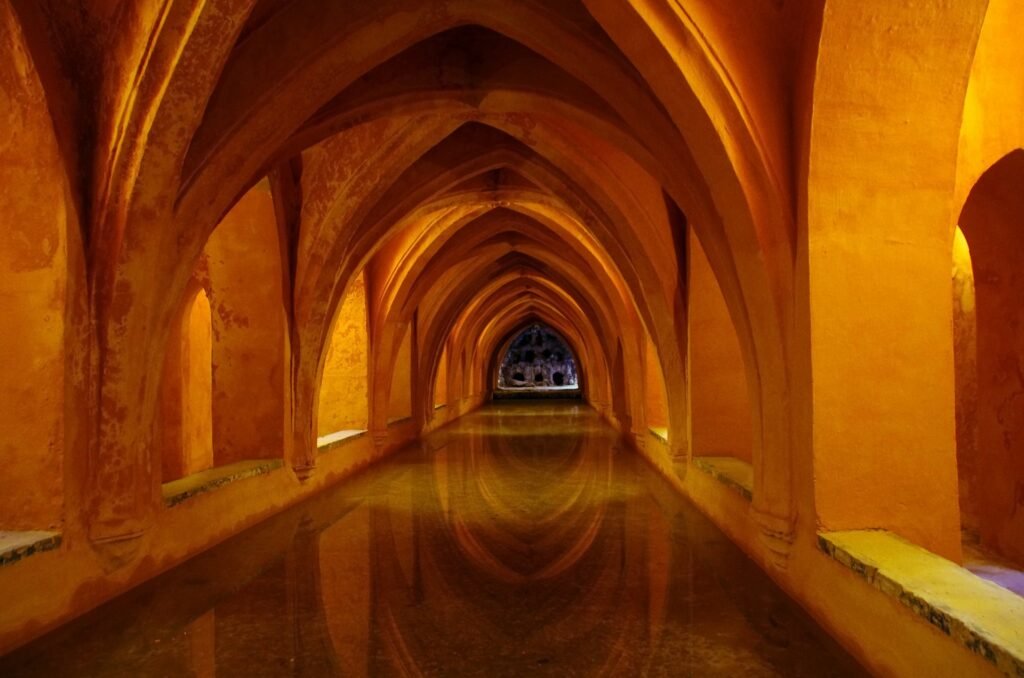 Moorish arches and ornate tilework inside the Real Alcázar of Seville, the oldest royal palace in Europe still in use